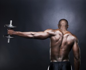 Young, male lifting dumbbell