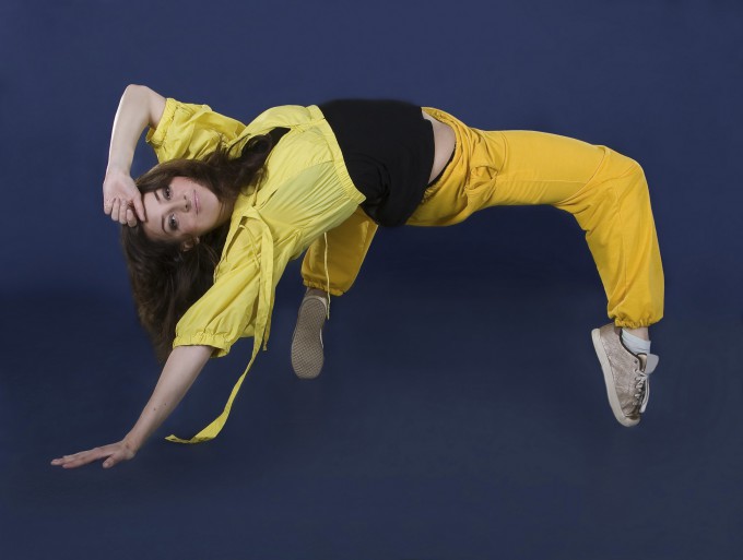 Teenage girl dancing hip-hop in the darkness