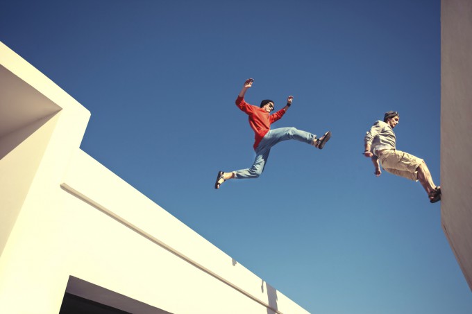 two brave men jumping over the roof